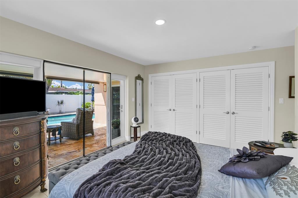 1616 Southeast 4th Street Deerfield Beach, FL 33441 - Photo 40 of 52 a bedroom with a bed and a flat screen tv