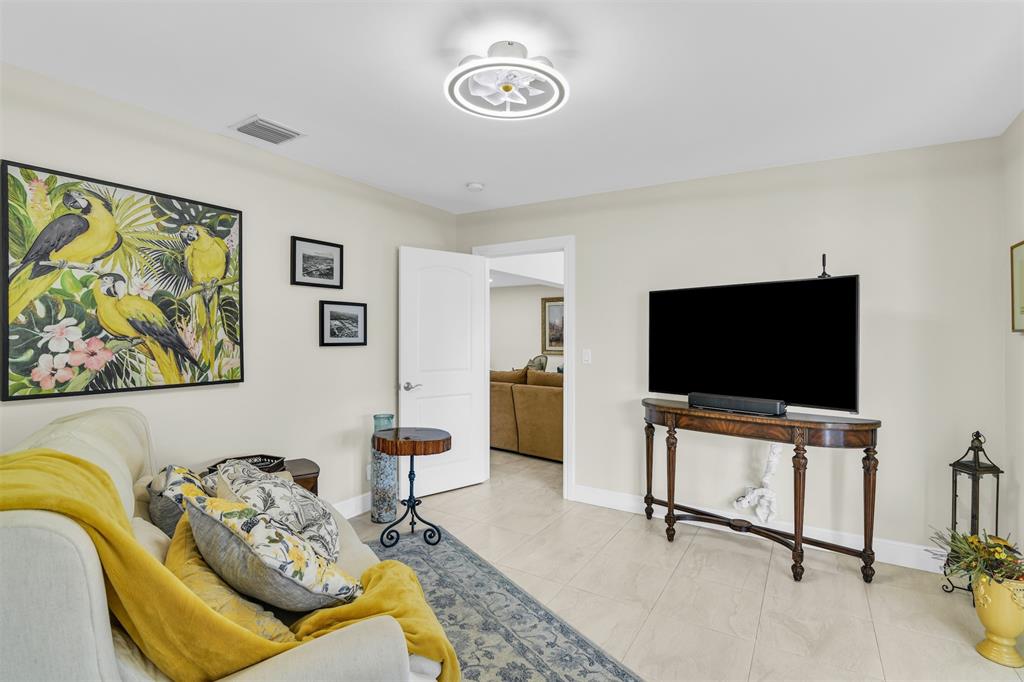 1616 Southeast 4th Street Deerfield Beach, FL 33441 - Photo 42 of 52 a living room with furniture and a flat screen tv