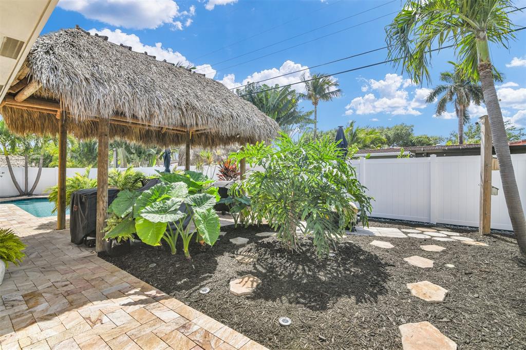 1616 Southeast 4th Street Deerfield Beach, FL 33441 - Photo 46 of 52 a view of a garden with an umbrella