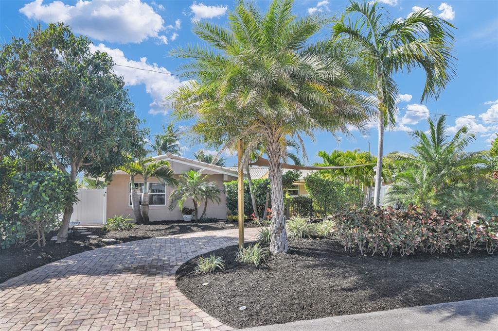 1616 Southeast 4th Street Deerfield Beach, FL 33441 - Photo 10 of 52 a front view of a house with garden