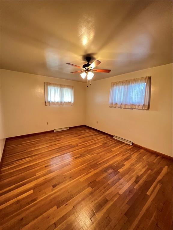 150 Wall Street Rochester, PA 15074 - Photo 13 of 23 an empty room with wooden floor chandelier fan and windows
