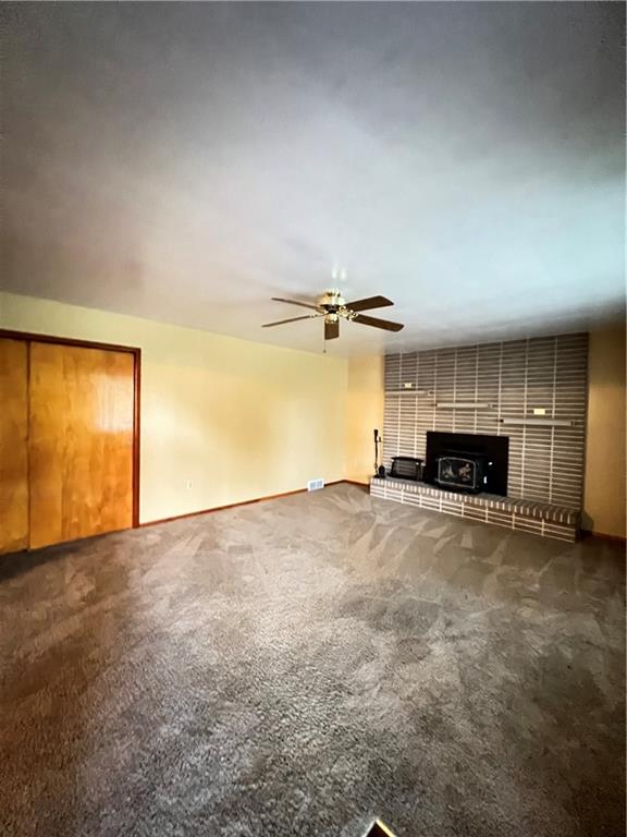150 Wall Street Rochester, PA 15074 - Photo 4 of 23 an empty room with a fireplace and wooden floor