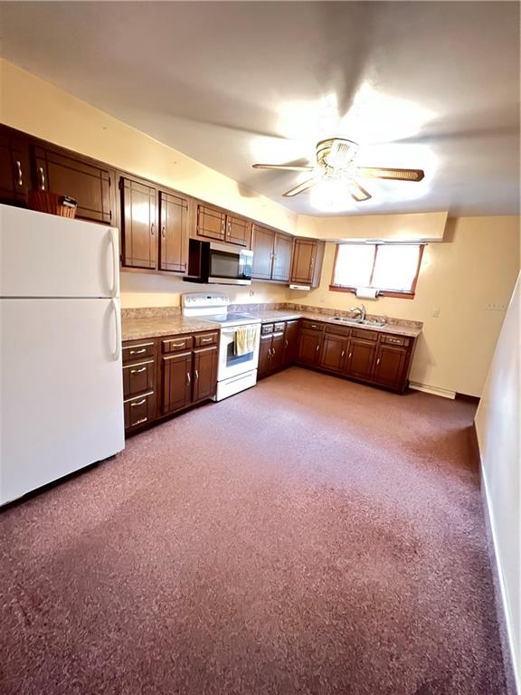 150 Wall Street Rochester, PA 15074 - Photo 7 of 23 a kitchen with kitchen island granite countertop a sink and refrigerator