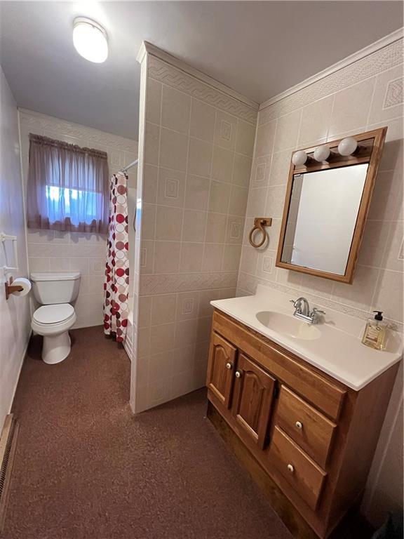 150 Wall Street Rochester, PA 15074 - Photo 9 of 23 a bathroom with a sink a toilet and a mirror