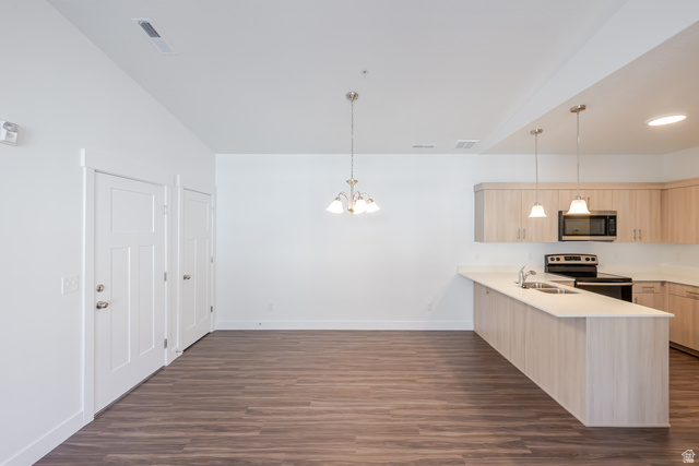4662 Poplar Way, Unit Q303 Mapleton, UT 84664 - Photo 8 of 18 Kitchen with a peninsula, light wood finish cabinetry, stainless steel appliances, dark wood finished floors, and hanging lights