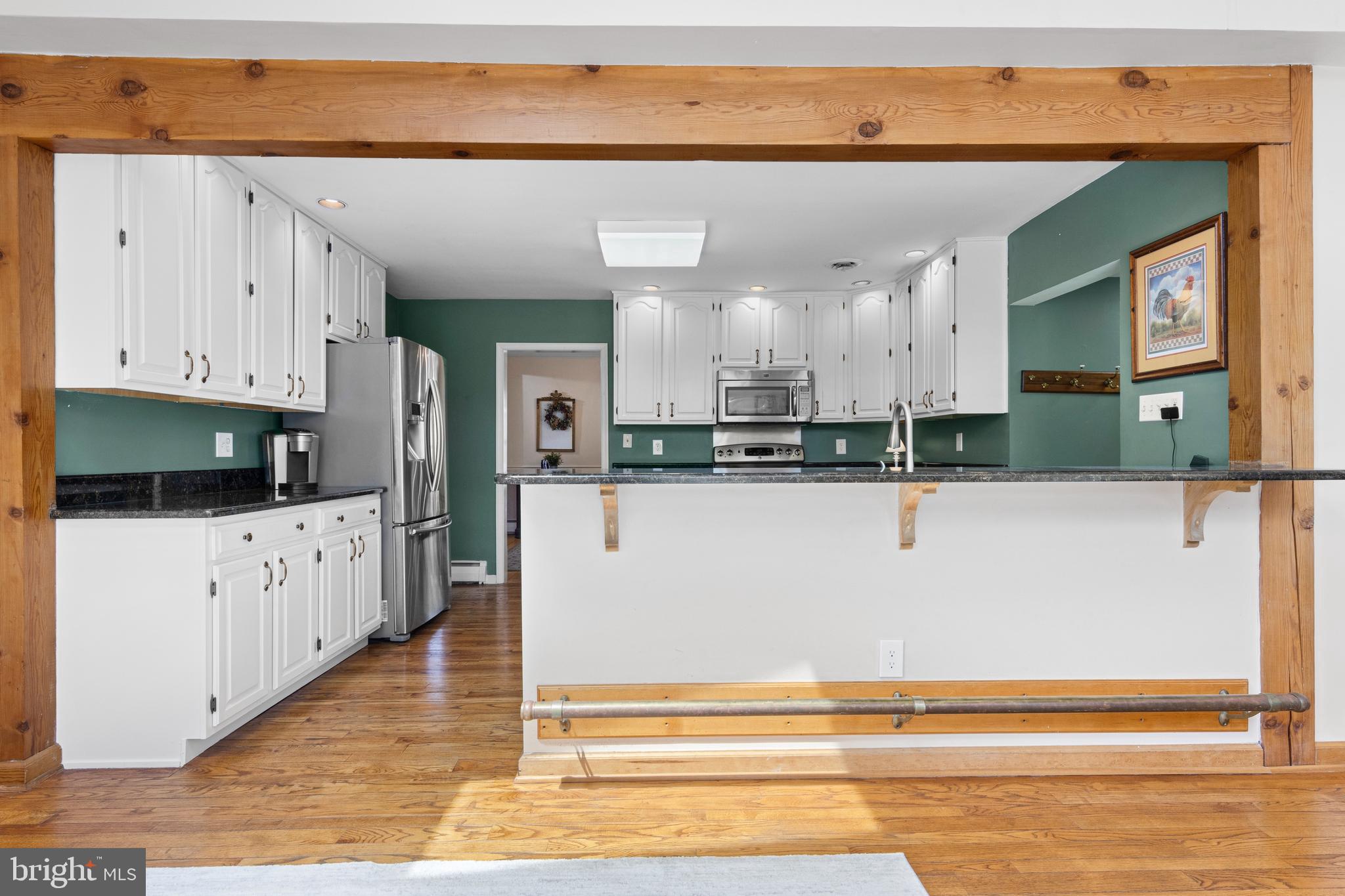 292 Old State Road Berwyn, PA 19312 - Photo 18 of 43 a large white kitchen with stainless steel appliances granite countertop a refrigerator a stove and a sink