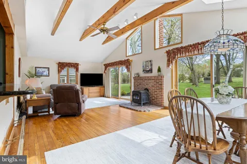 a living room with fireplace furniture and a floor to ceiling window