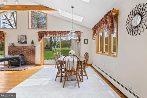 a dining room with furniture a chandelier and wooden floor