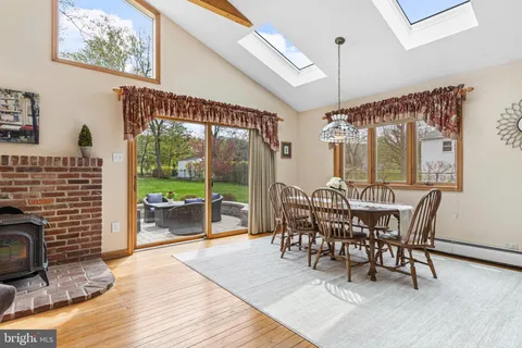 a living room with furniture a flat screen tv and a floor to ceiling window