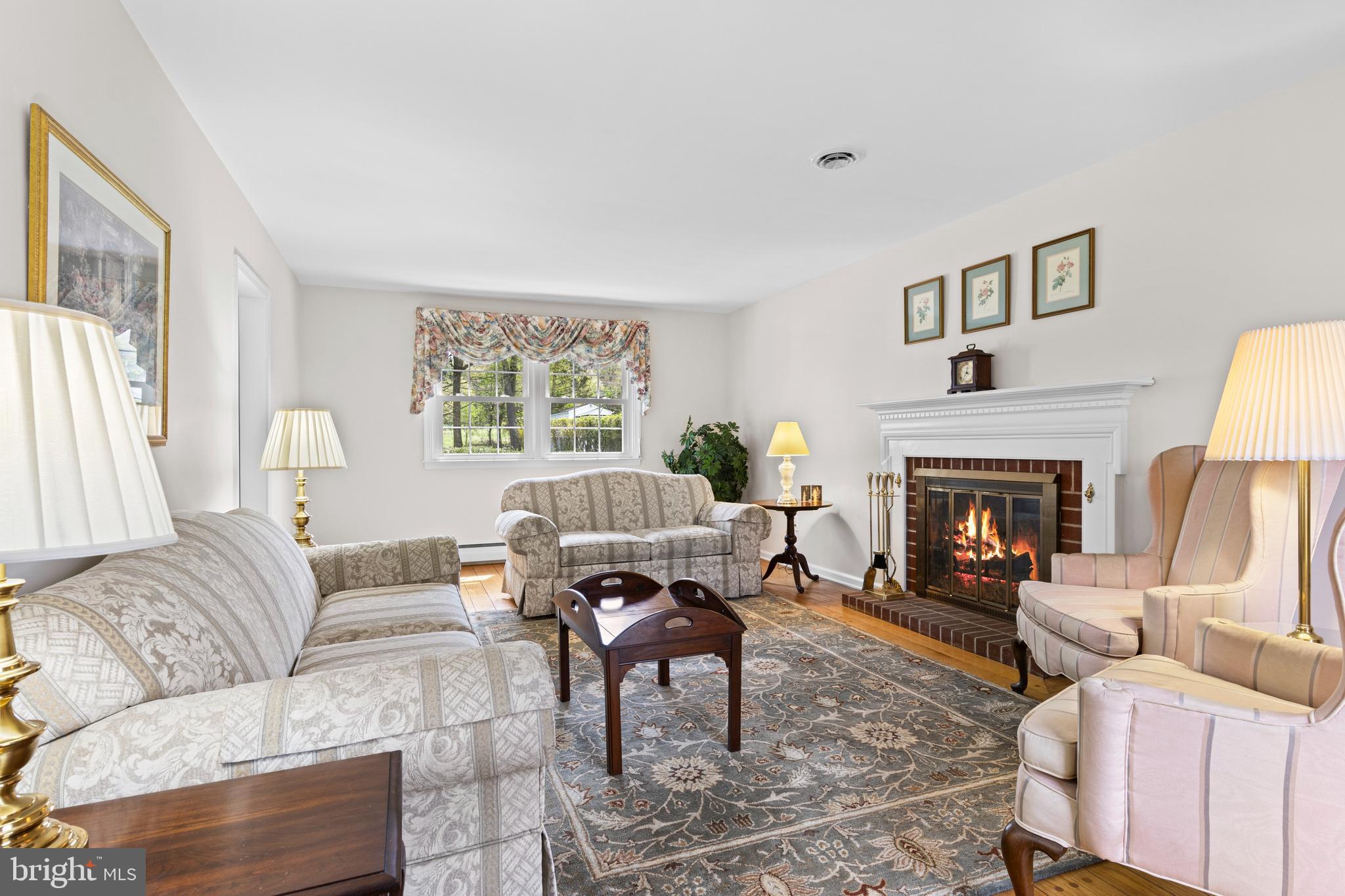 292 Old State Road Berwyn, PA 19312 - Photo 5 of 43 a living room with furniture a fireplace and a large window