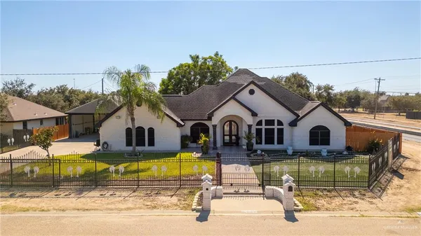 a view of a house with swimming pool and a yard