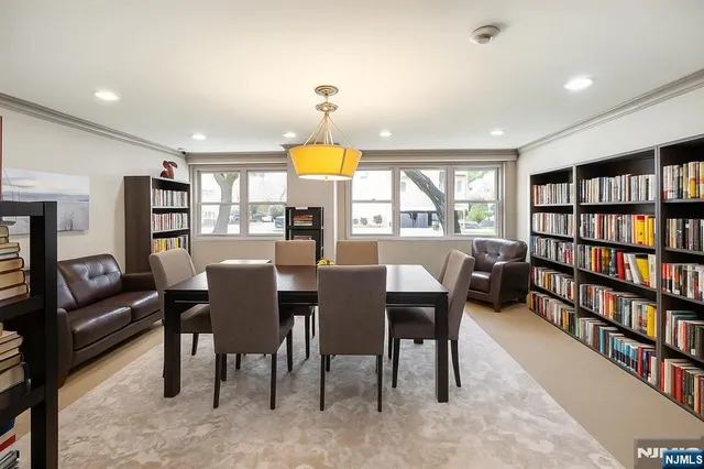 a view of a a dining room with furniture window and wooden floor