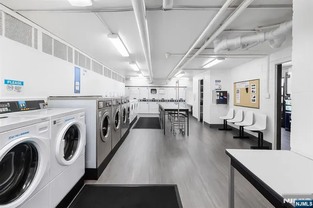a view of a kitchen with furniture and wooden floor