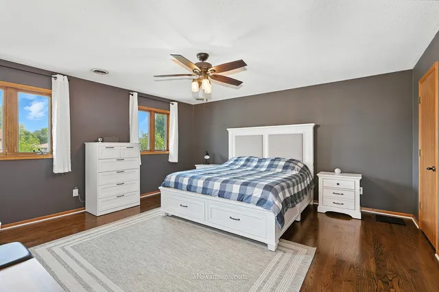 a bedroom with a large bed and a chandelier