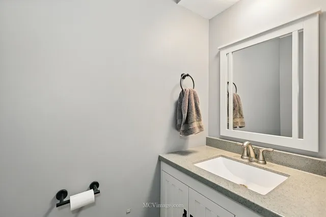 a bathroom with a sink vanity and a mirror
