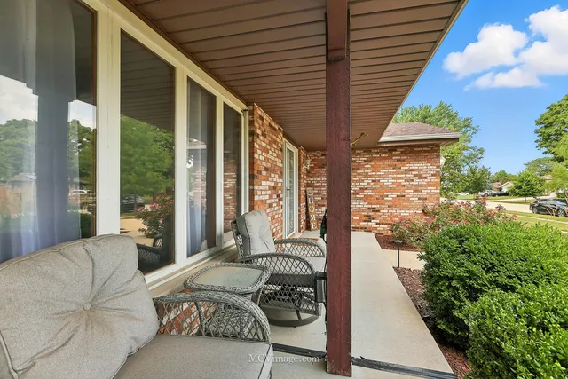 a balcony with furniture and a potted plant