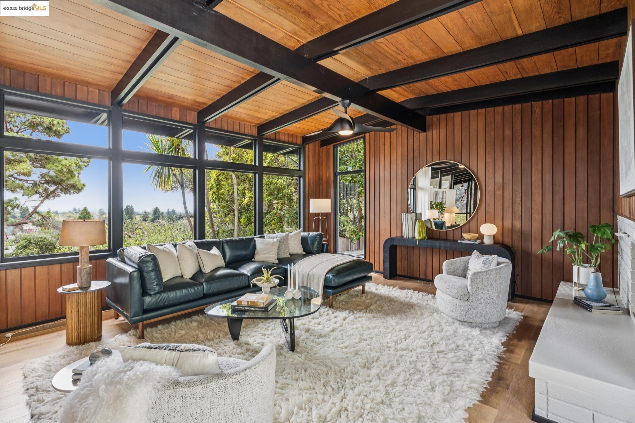 a living room with furniture and floor to ceiling windows