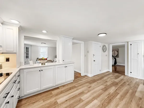 a large white kitchen with a sink