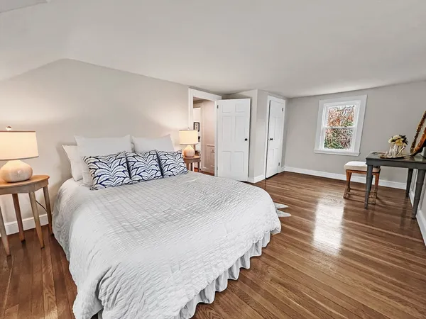 a bedroom with bed and window