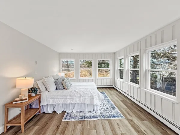 a bedroom with a bed and wooden floor