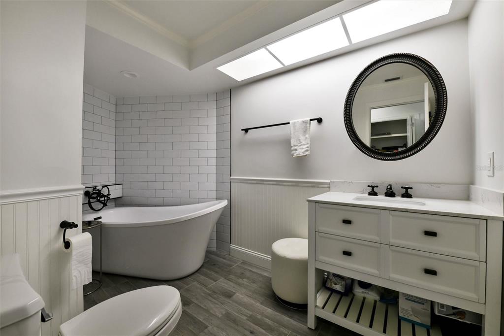 1875 Belleair Road Clearwater, FL 33764 - Photo 54 of 100 a bathroom with a toilet a sink and mirror
