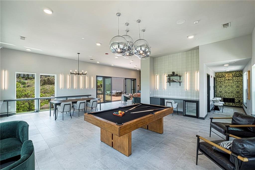 72 Milton Avenue Southeast, Unit 3407 Atlanta, GA 30315 - Photo 18 of 27 a living room with furniture pool table and a large window