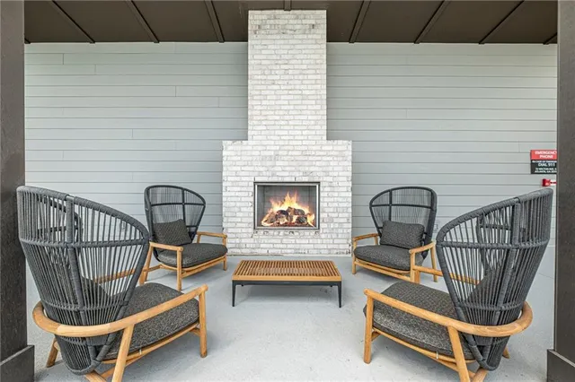 a view of a balcony with two chairs and a fireplace