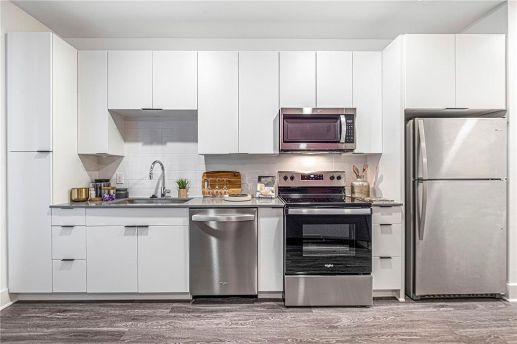 72 Milton Avenue Southeast, Unit 3407 Atlanta, GA 30315 - Photo 4 of 27 a kitchen with stainless steel appliances a refrigerator stove and microwave