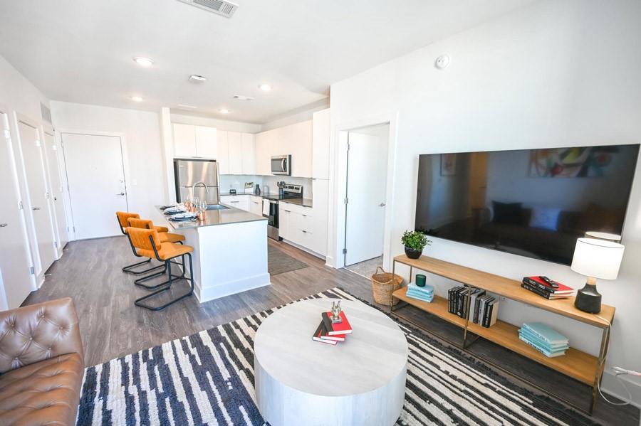 72 Milton Avenue Southeast, Unit 3407 Atlanta, GA 30315 - Photo 6 of 27 a living room with furniture and a flat screen tv
