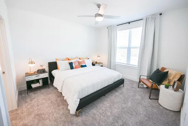 a bed room with a bed and a chair