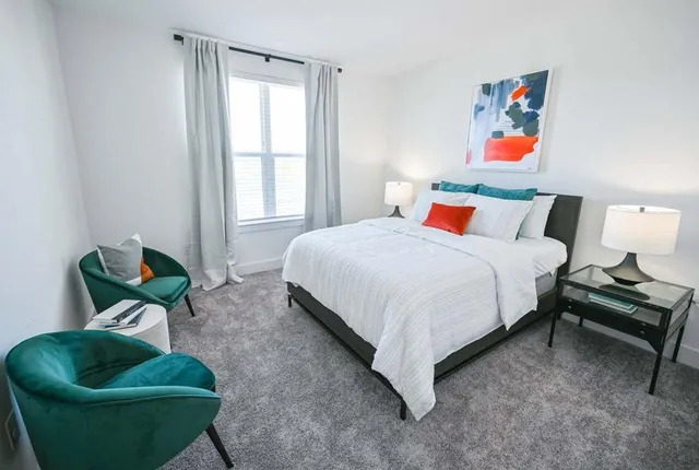 a bedroom with a bed and couch