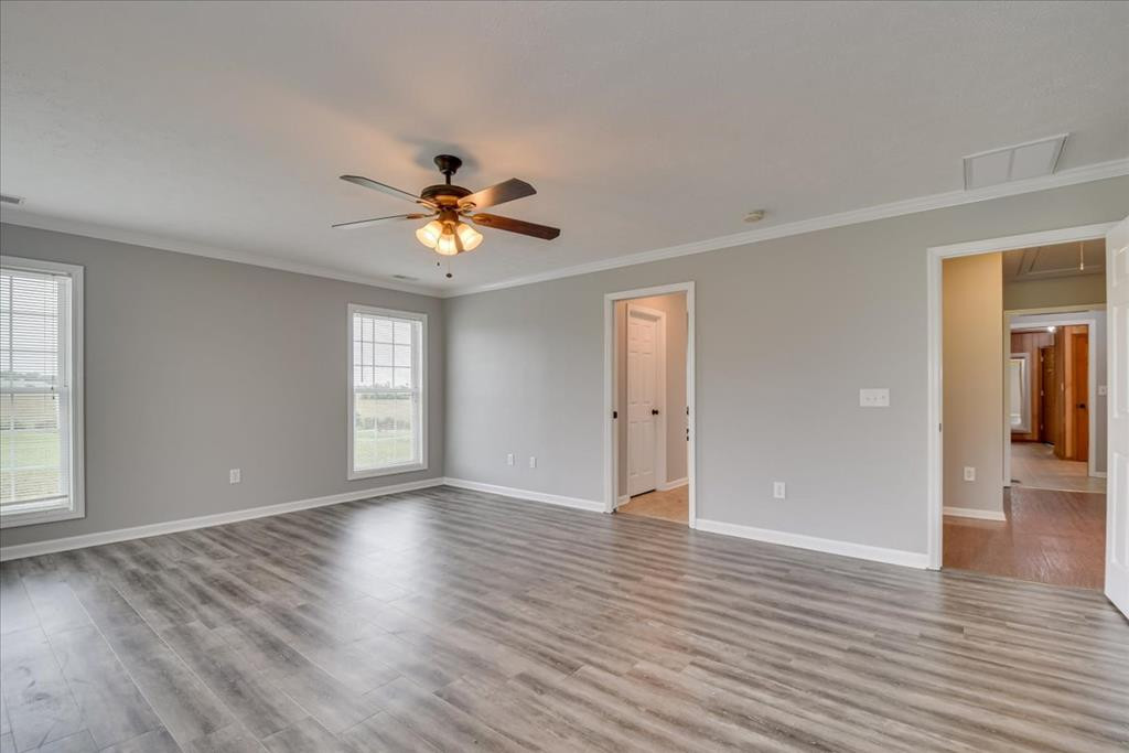 1673 Coleman Bridge Road Wagener, SC 29164 - Photo 20 of 45 a view of an empty room with window and wooden floor
