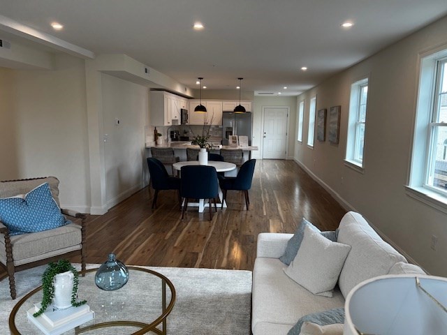 1 Pleasant Street, Unit 206 Cohasset, MA 02025 - Photo 10 of 11 a living room with furniture a dining table and a potted plant