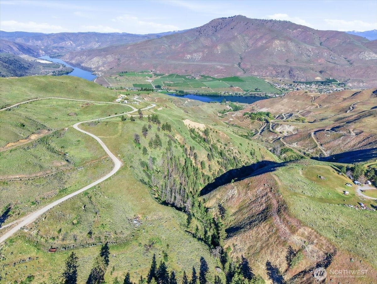 25 Chelan Hills Acres Road Orondo, WA 98843 - Photo 18 of 39 a view of a lake with a mountain in the background