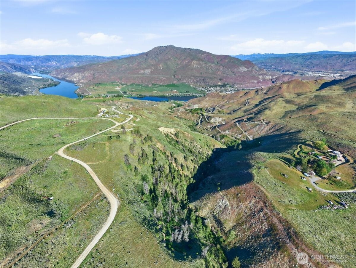25 Chelan Hills Acres Road Orondo, WA 98843 - Photo 37 of 39 a view of a lush green hillside and a houses