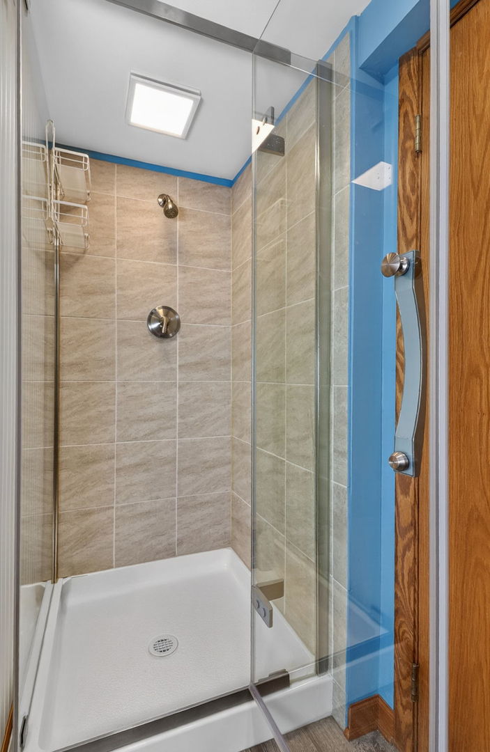 2123 Green Valley Road Darien, IL 60561 - Photo 23 of 30 a bathroom with a bathtub and a shower