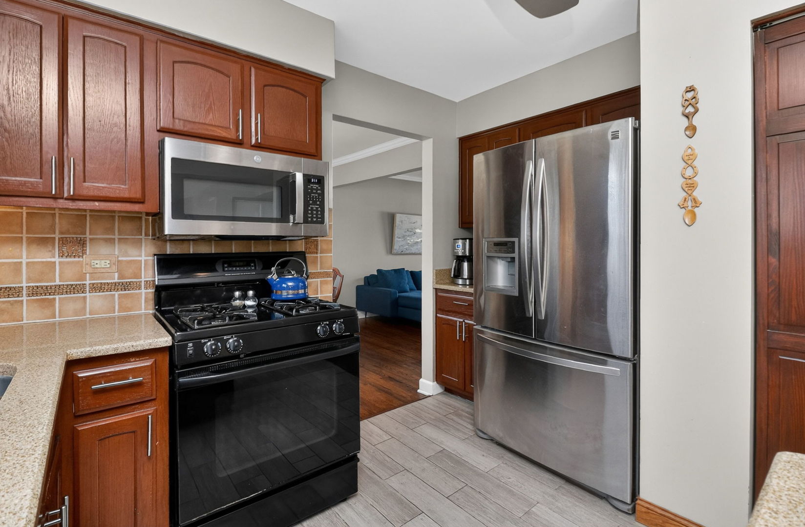2123 Green Valley Road Darien, IL 60561 - Photo 8 of 30 a kitchen with granite countertop stainless steel appliances and wooden cabinets
