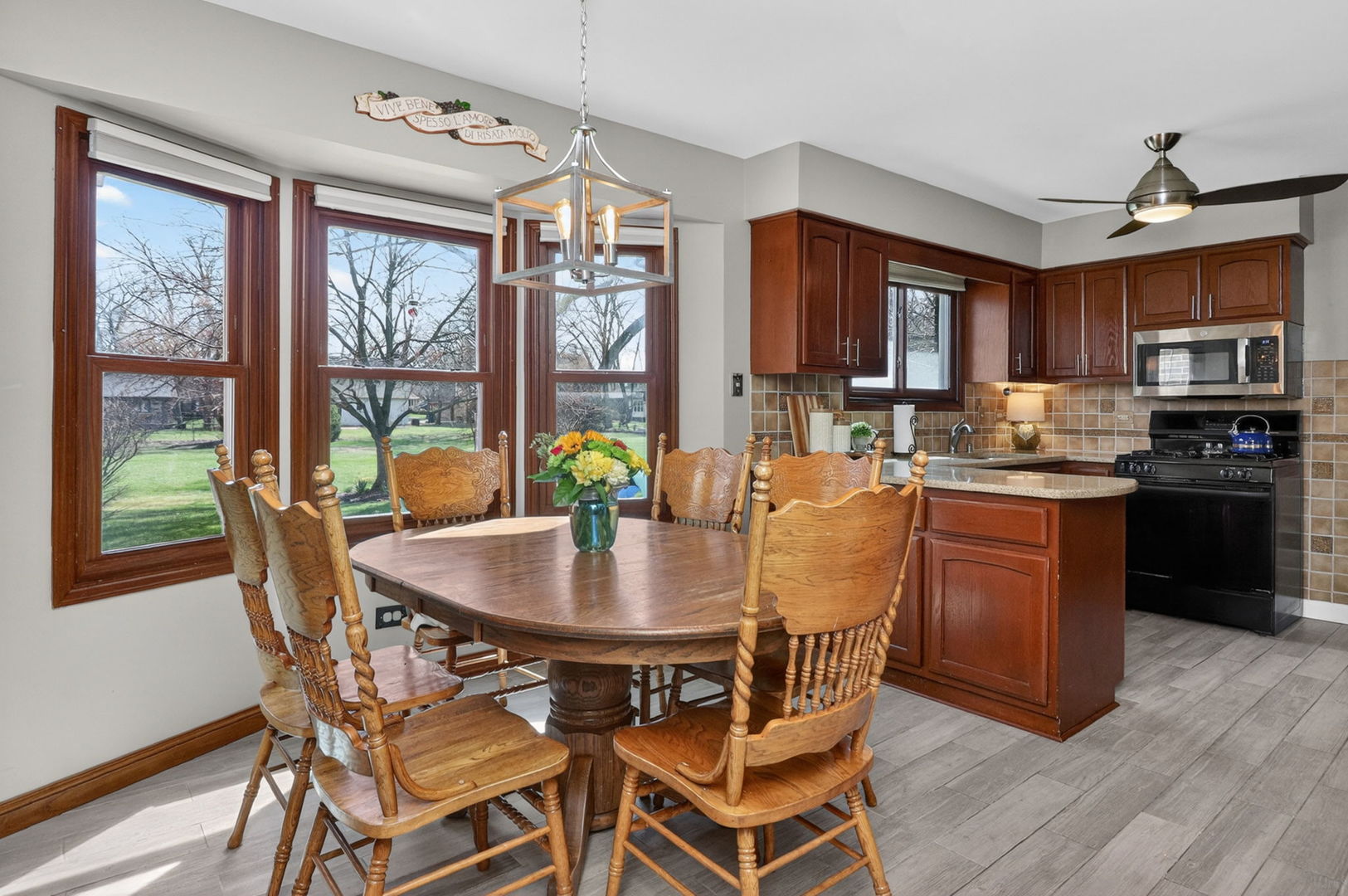 2123 Green Valley Road Darien, IL 60561 - Photo 9 of 30 a dining room with furniture a chandelier and wooden floor