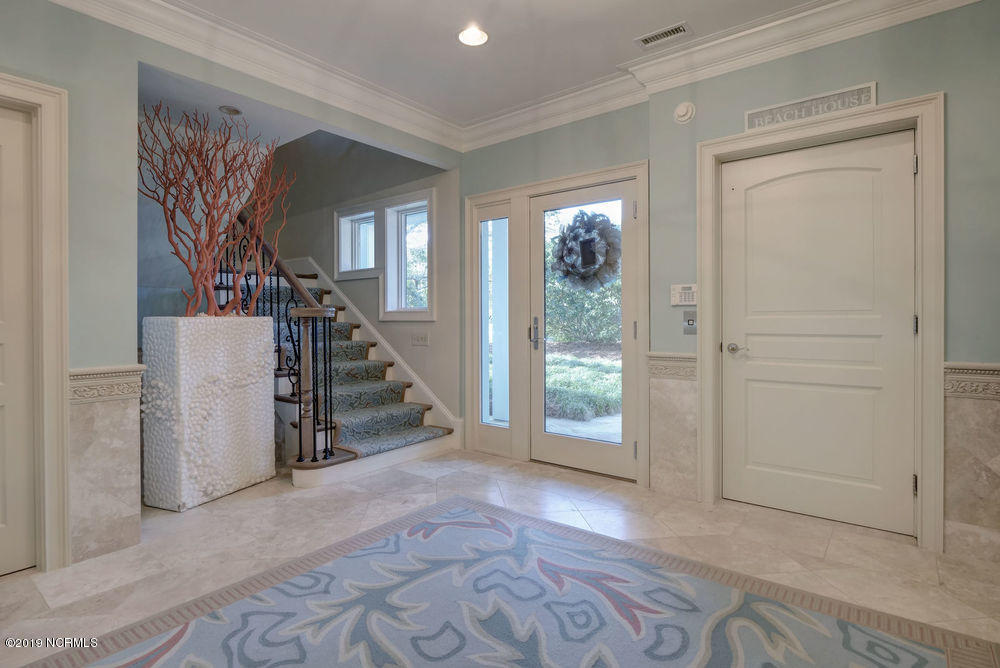 264 Beach Road North Wilmington, NC 28411 - Photo 12 of 51 The elevator is located to the right of the front door, right inside the double garages for easy loading of groceries and luggage.