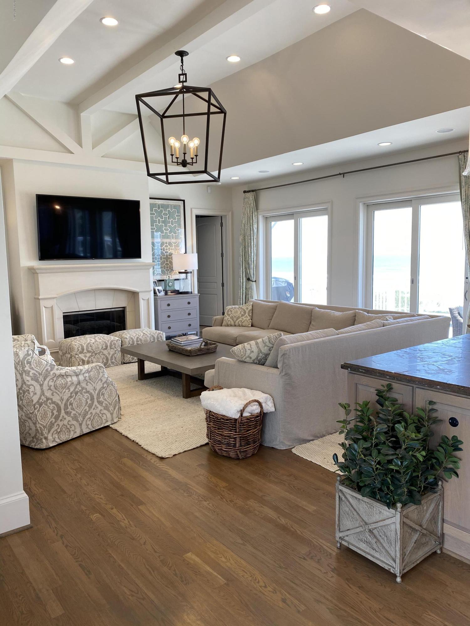 264 Beach Road North Wilmington, NC 28411 - Photo 14 of 51 Main Living area on top floor open to kitchen and spacious deck overlooking the beach.