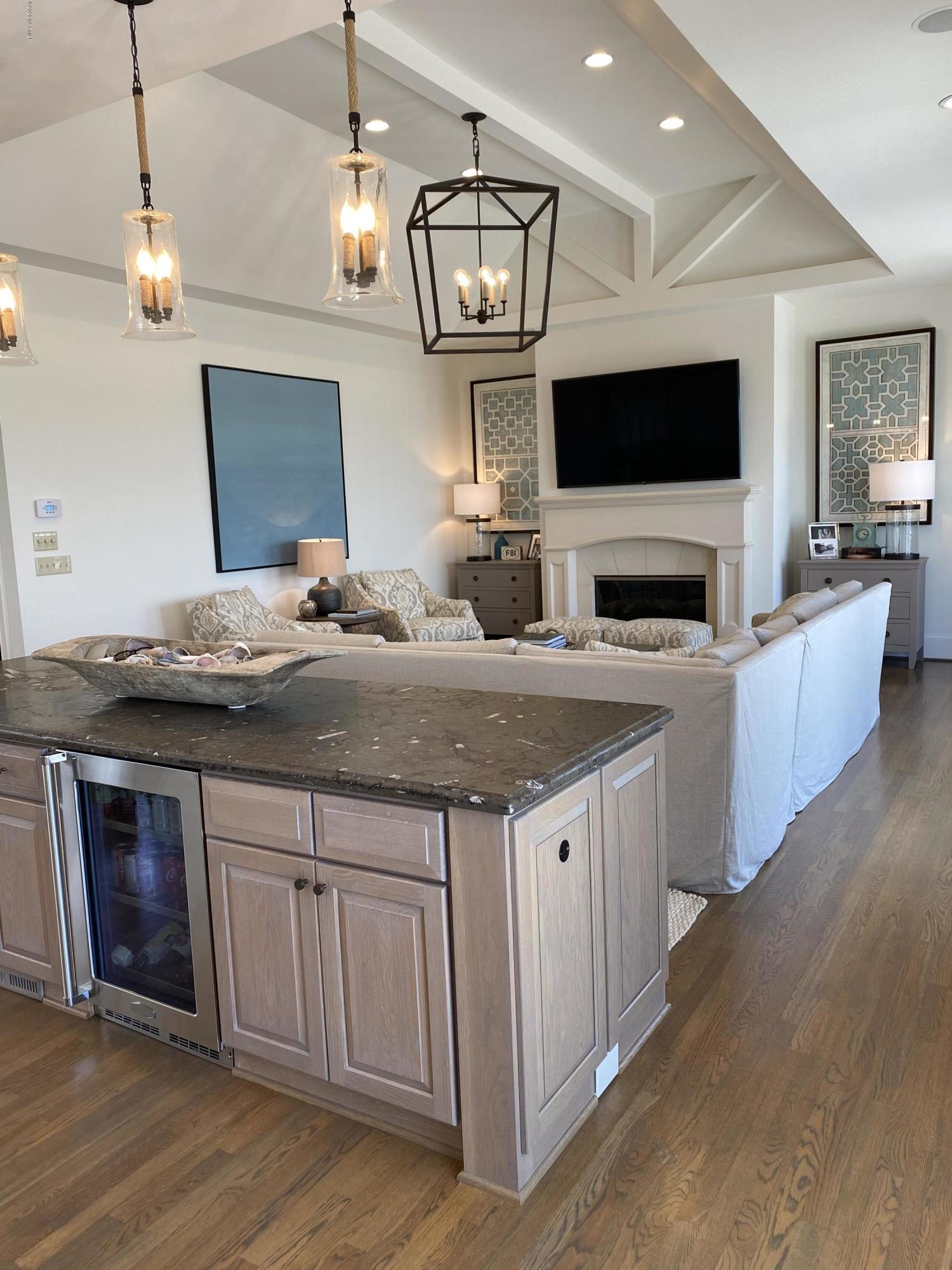 264 Beach Road North Wilmington, NC 28411 - Photo 17 of 51 Bar area with beautiful natural fossil counter top. Separates dining are living areas.