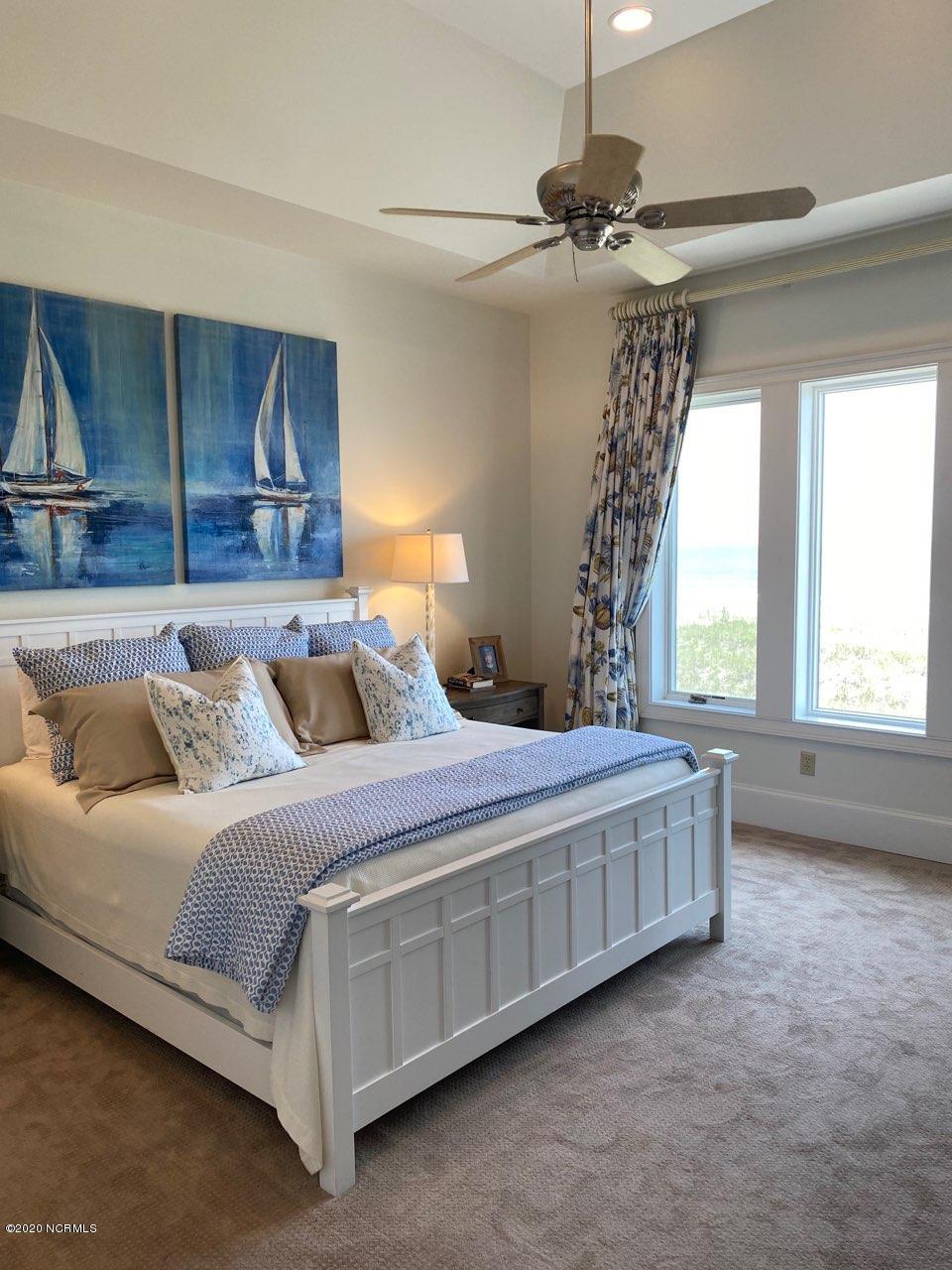 264 Beach Road North Wilmington, NC 28411 - Photo 27 of 51 Owners Bedroom with views of the ocean. Huge walk-in closets and incredible bathroom with 2 johns.