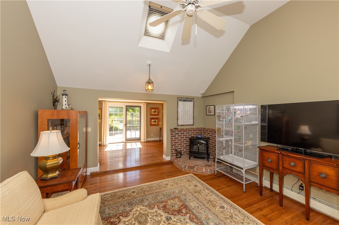 8405 Dines Road Novelty, OH 44072 - Photo 24 of 45 Third view of recreation room featuring electric heater, beautiful hardwood floors and sliders leading to back deck.