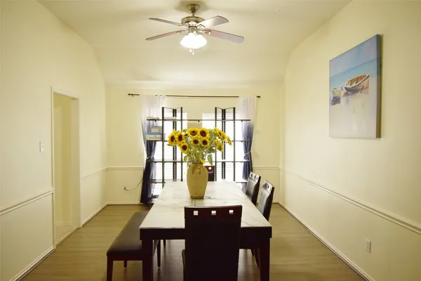 a view of a dining room with furniture and chandelier