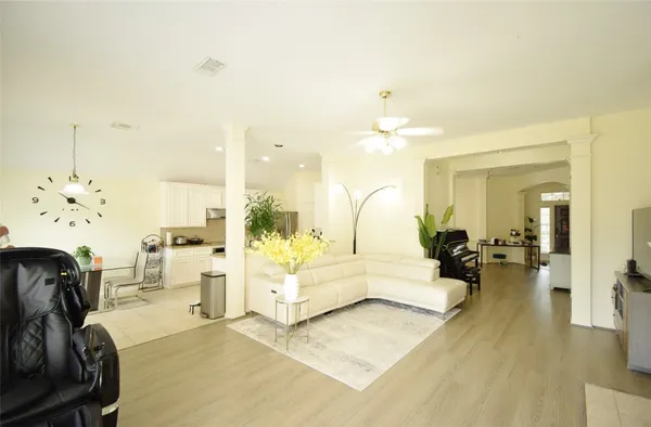 a living room with furniture and a chandelier
