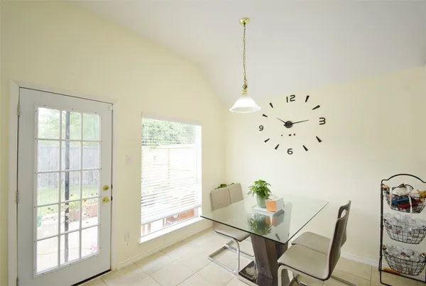 a view of a workspace with furniture and window