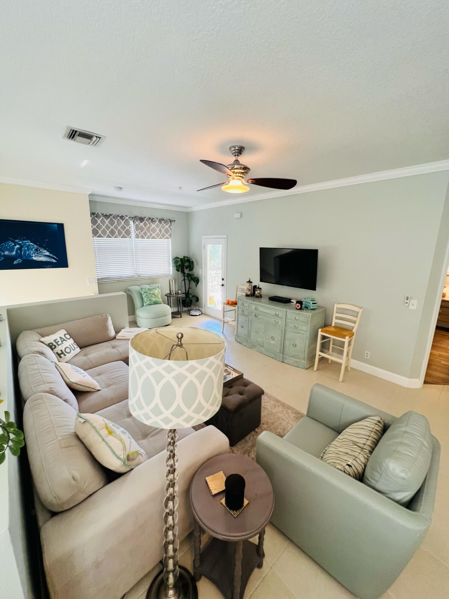 115 Lighthouse Circle, Unit B Tequesta, FL 33469 - Photo 5 of 19 a living room with furniture and a flat screen tv