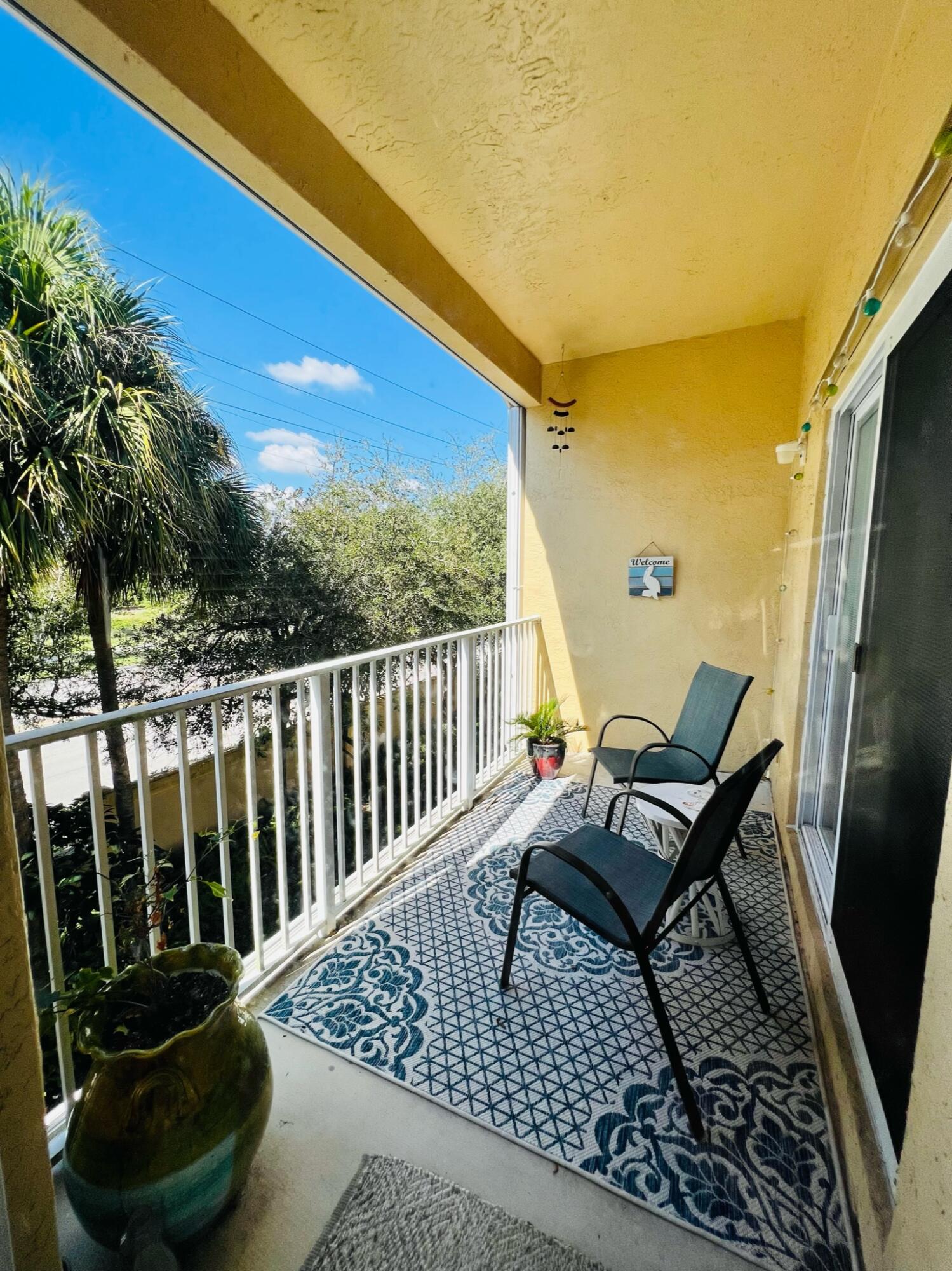 115 Lighthouse Circle, Unit B Tequesta, FL 33469 - Photo 8 of 19 a view of a chairs and table in the balcony