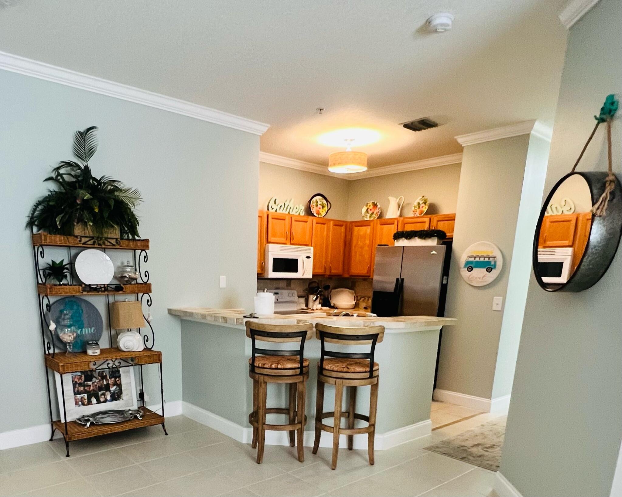 115 Lighthouse Circle, Unit B Tequesta, FL 33469 - Photo 10 of 19 a dining hall with granite countertop a sink and a mirror