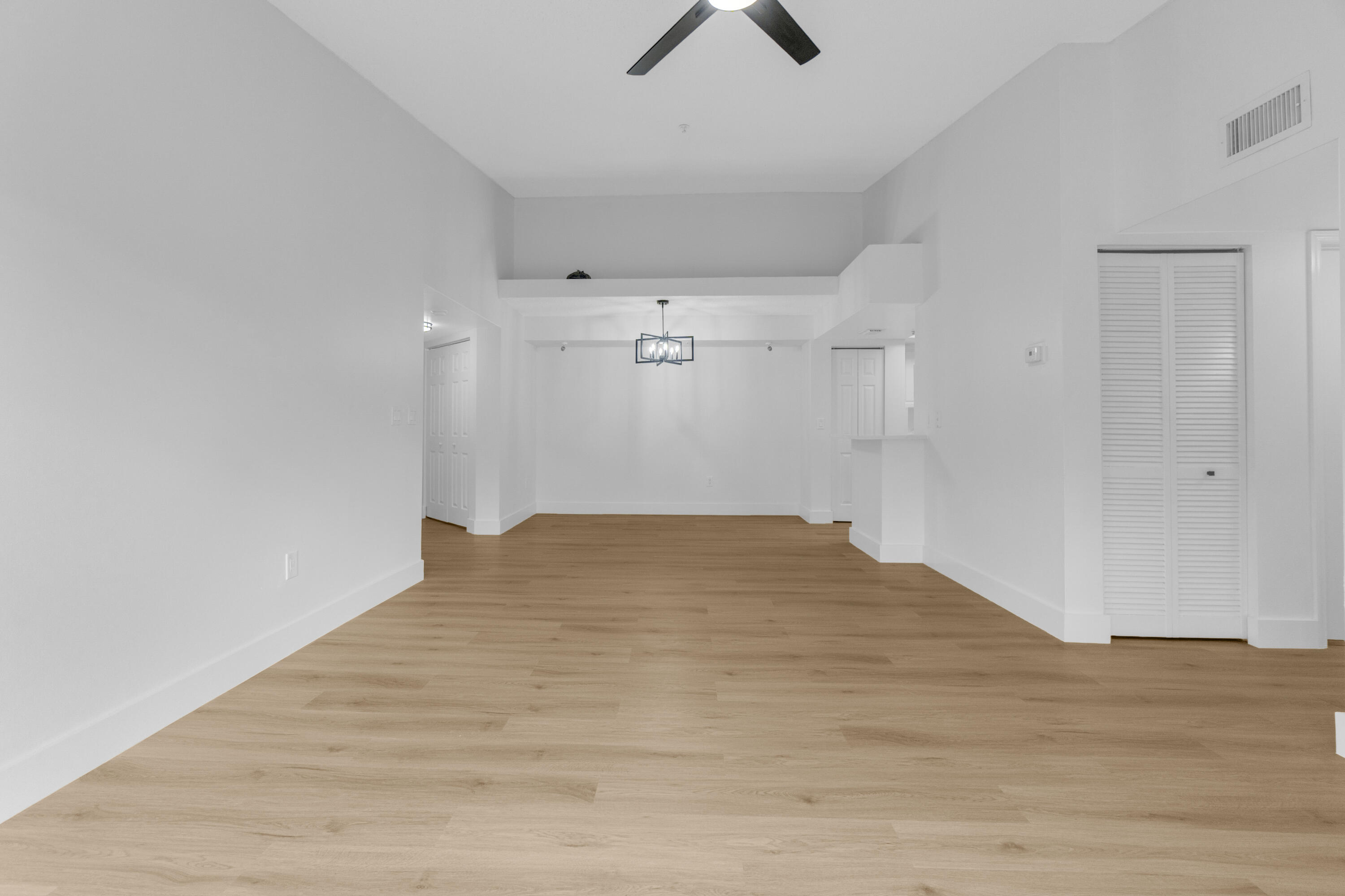 400 Crestwood Court North, Unit 420 Royal Palm Beach, FL 33411 - Photo 11 of 44 a view of empty room with wooden floor and ceiling fan